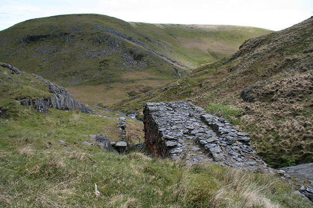 The massive stone walls of the waterwheel pit at Nant y Garw mine, Ceredigion, which once powered a line of reciprocating flat rods to the engine shaft.