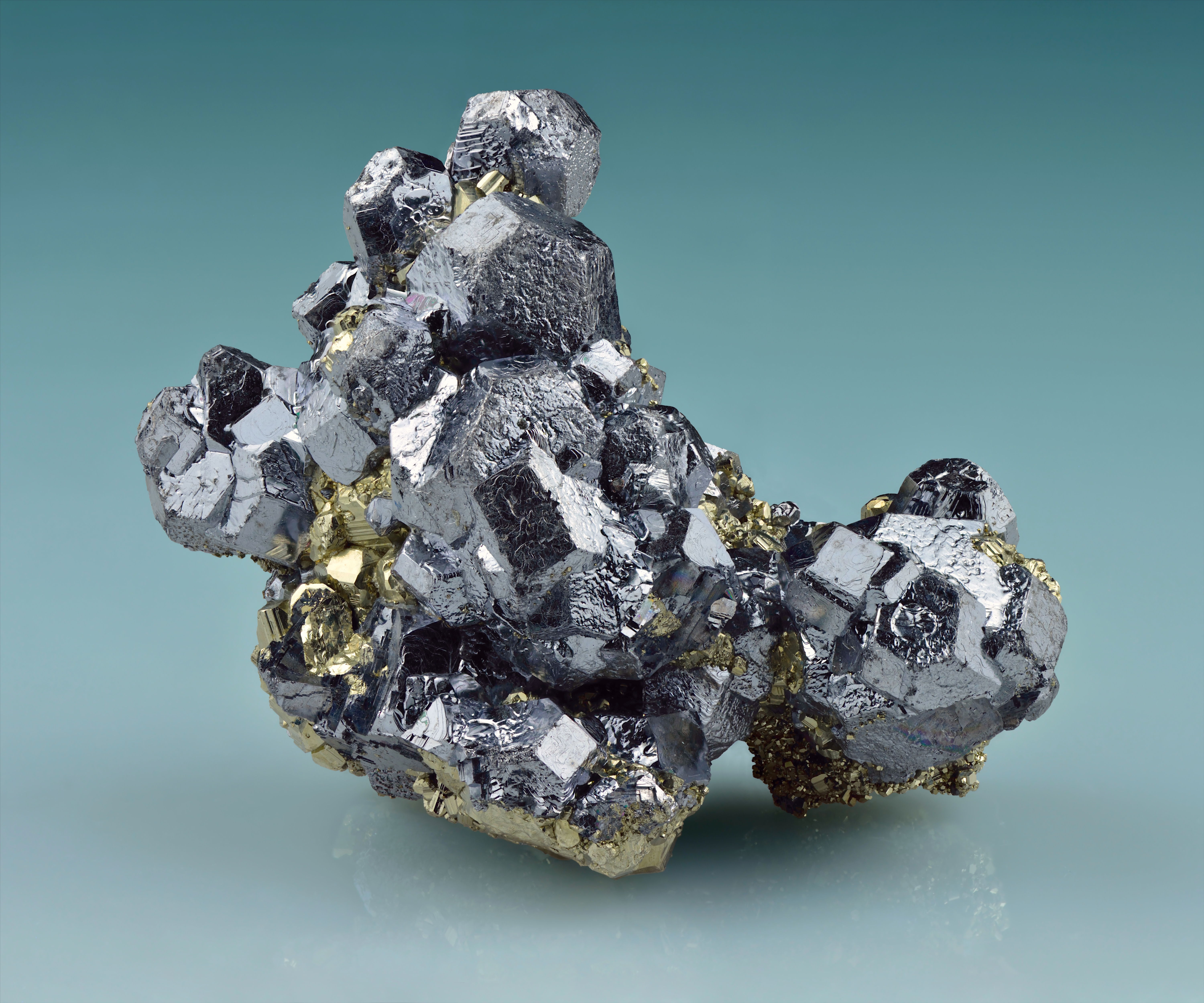 A cluster of galena crystals with golden pyrite, showing the mineral's characteristic cubic cleavage.