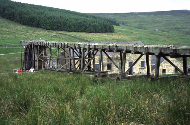 An elevated wooden trough, or launder, carrying water to the large waterwheel at Killhope Lead Mining Museum.