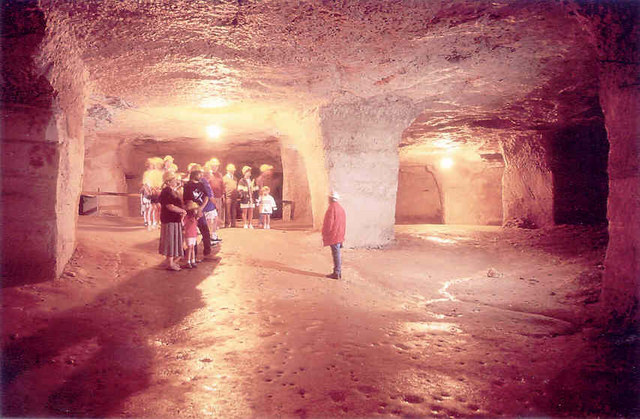 Rock-cut pillars and chambers in the underground limestone workings at Beer Quarry Caves, Devon, showing the room-and-pillar method used across Britain's underground limestone mines.