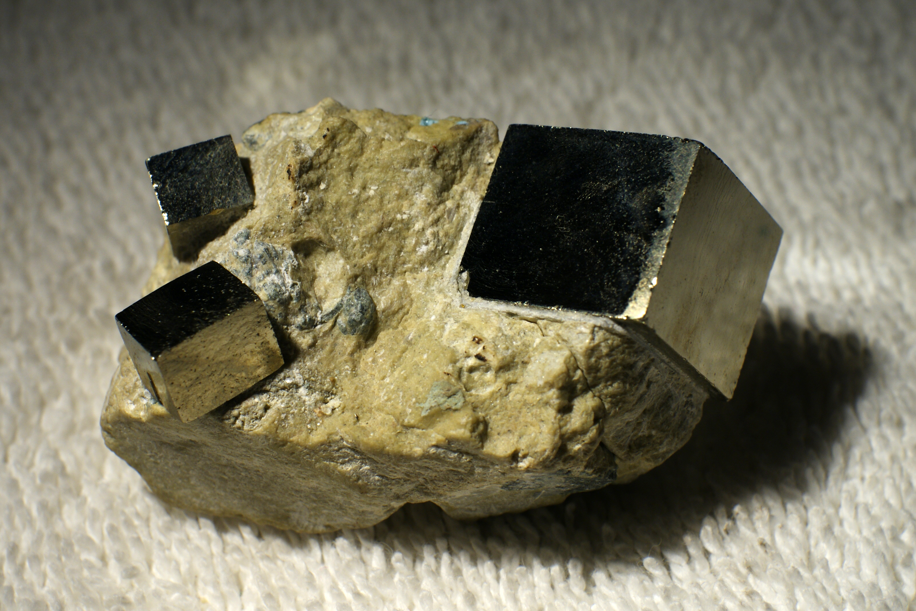 Cubic pyrite crystals showing the mineral's characteristic brassy-yellow metallic lustre, the source of its 'fool's gold' nickname.