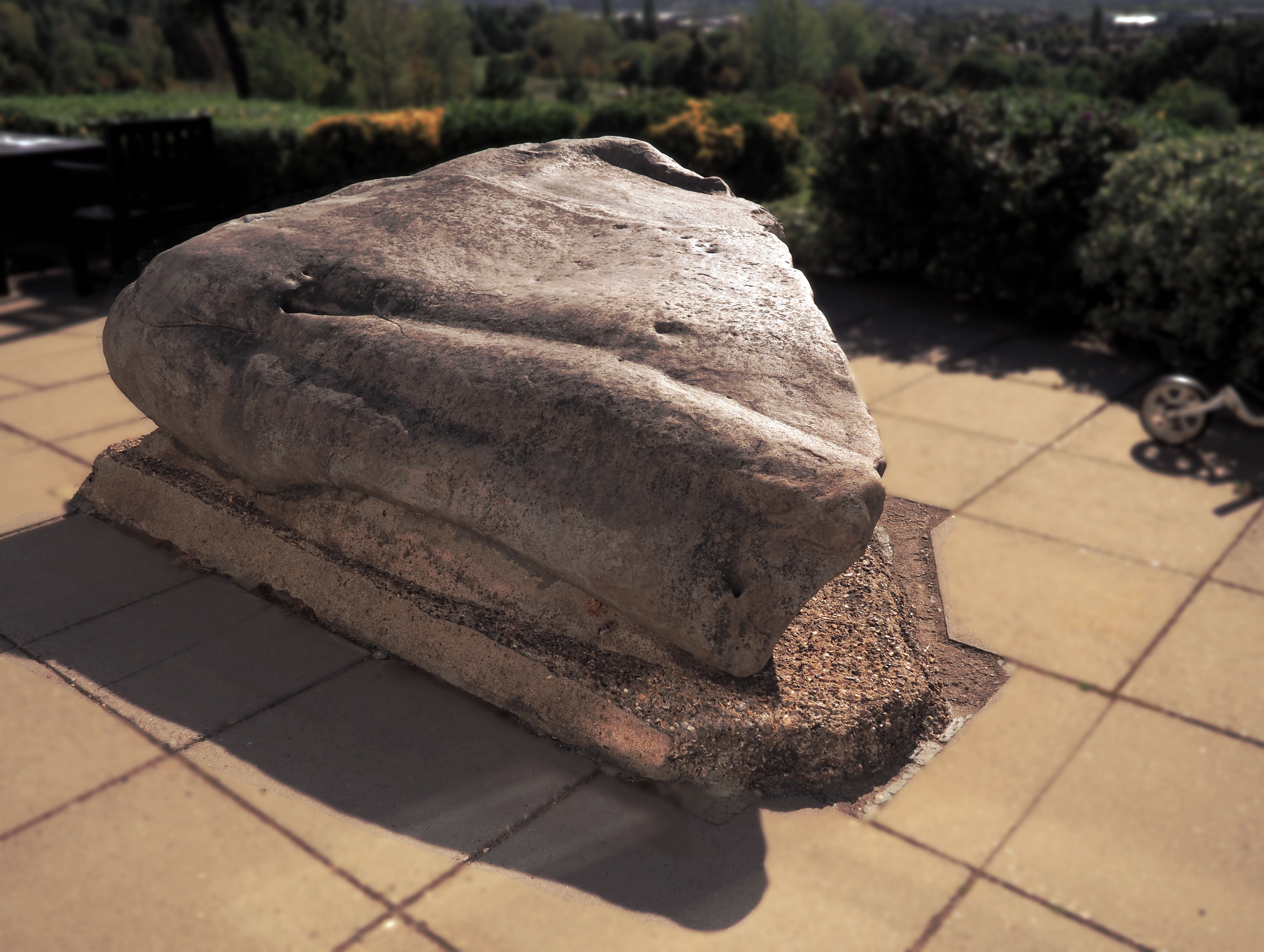 A large sarsen boulder, the Sudbury Stone, set on a raised plinth at Sudbury Golf Club, London.