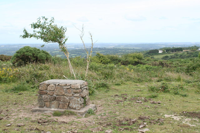 A concrete-capped mine shaft standing above rough ground at Buller Downs, near Lanner in Cornwall.