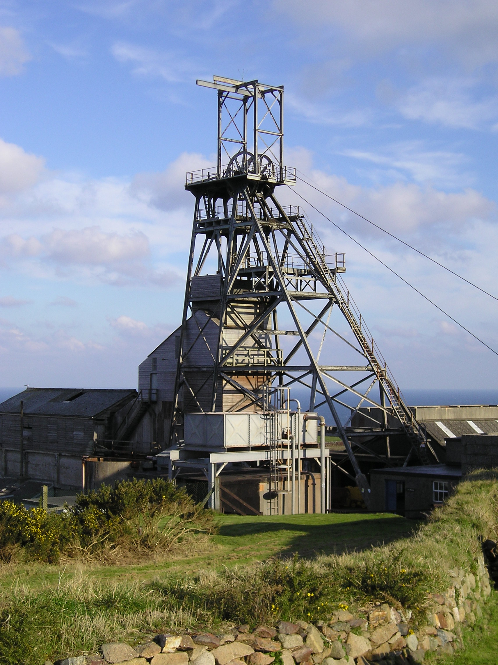 The steel headframe standing directly over Victory Shaft at Geevor Tin Mine, Cornwall — the surface structure marking a shaft sunk to 460 metres deep.