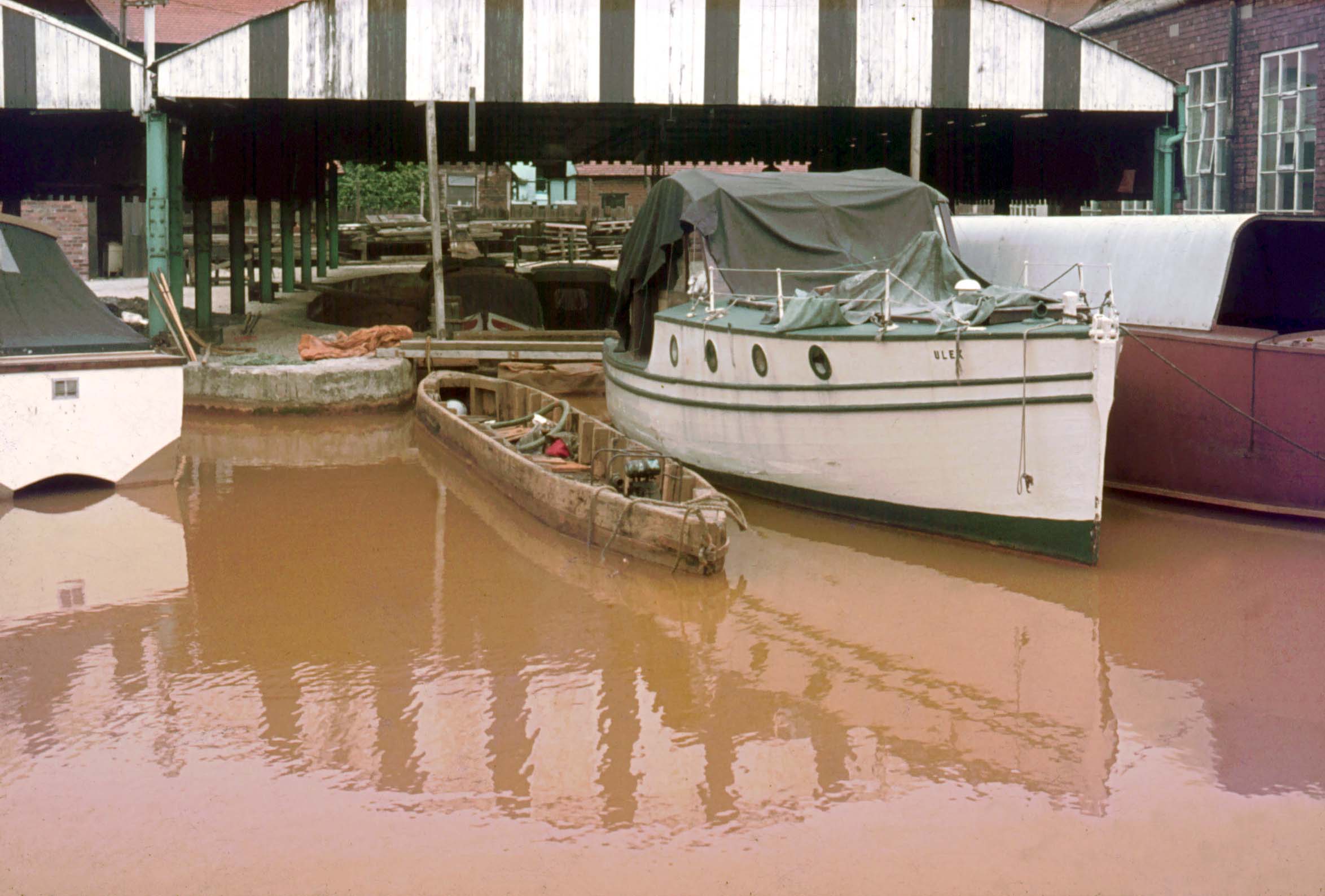 An original starvationer coal barge in dock at Worsley in 1974, showing its narrow, deeply ribbed hull.