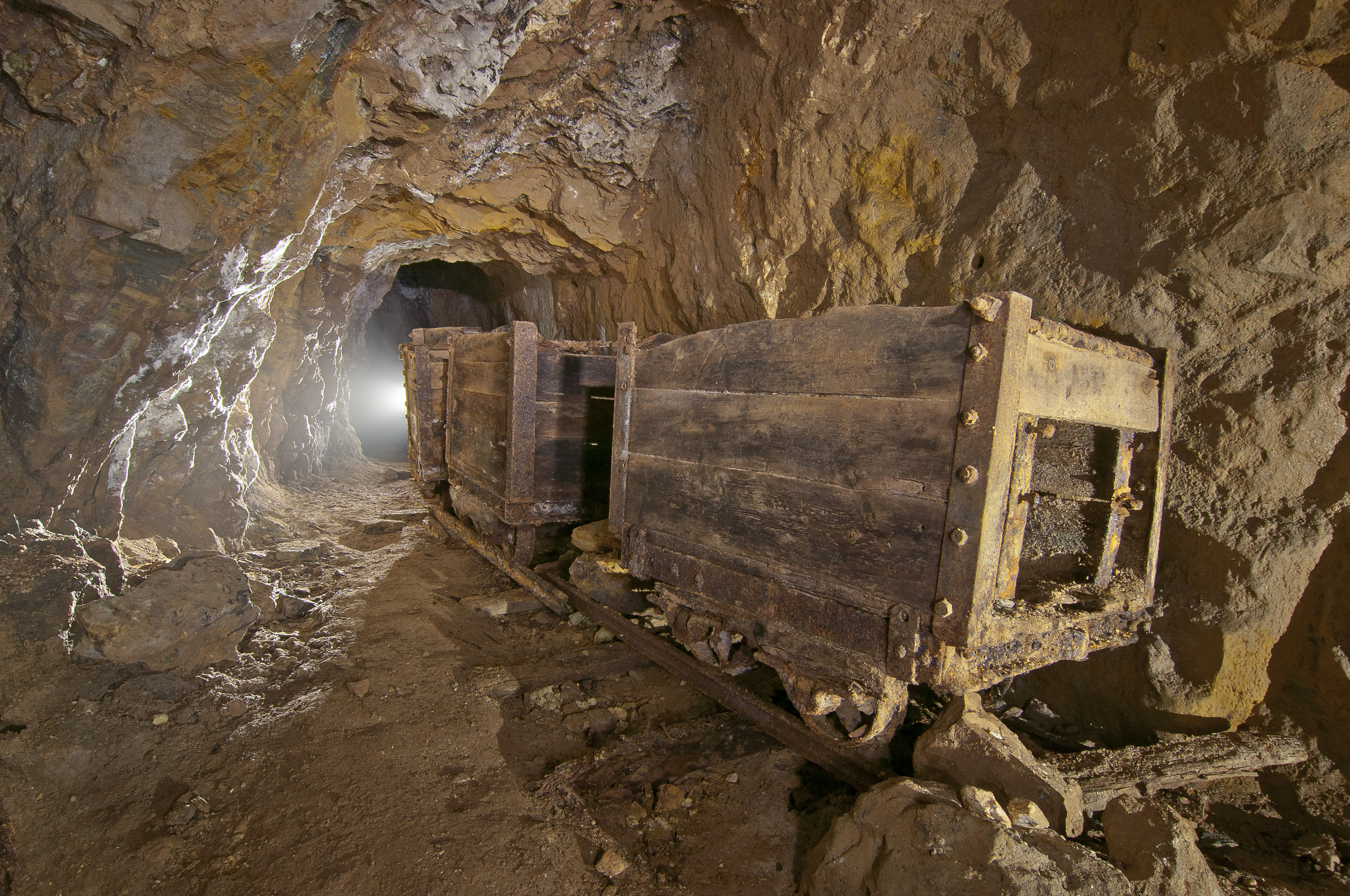A rake of underground mine tubs on narrow-gauge rails at Force Crag Mine, Cumbria.