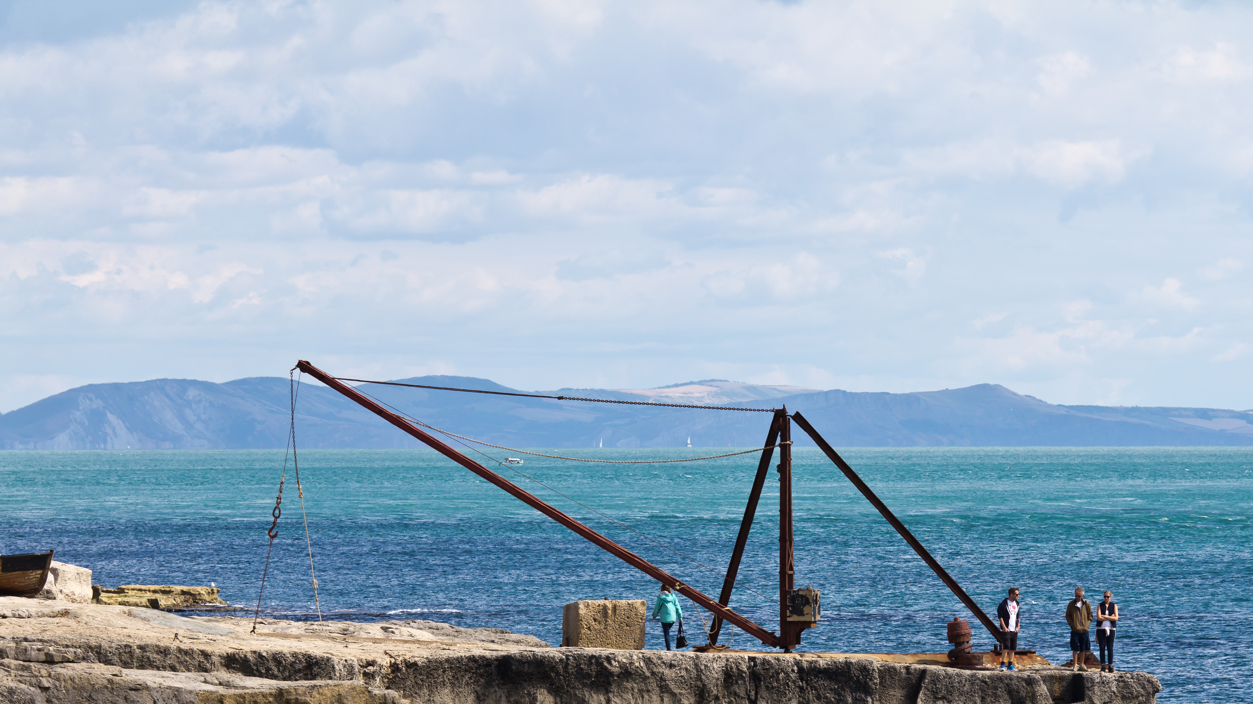 The Red Crane at Portland Bill, a later ironwork example of the same mast-and-jib design used by wooden whim cranes to swing and lower quarried stone down to waiting boats.