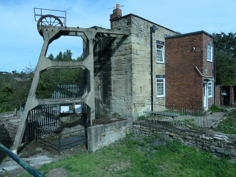 The concrete headframe over Hemingfield's pumping shaft beside the stone Cornish engine house, now a dwelling, 2019
