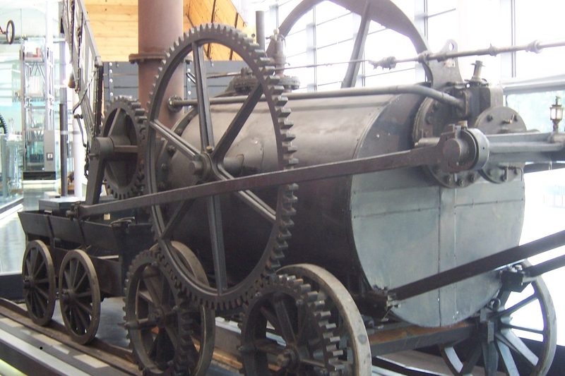 A museum replica of Richard Trevithick's 1804 steam locomotive, showing its large toothed driving wheels and cylindrical boiler, on display at the National Waterfront Museum, Swansea (not the original engine, and not at Penydarren itself).