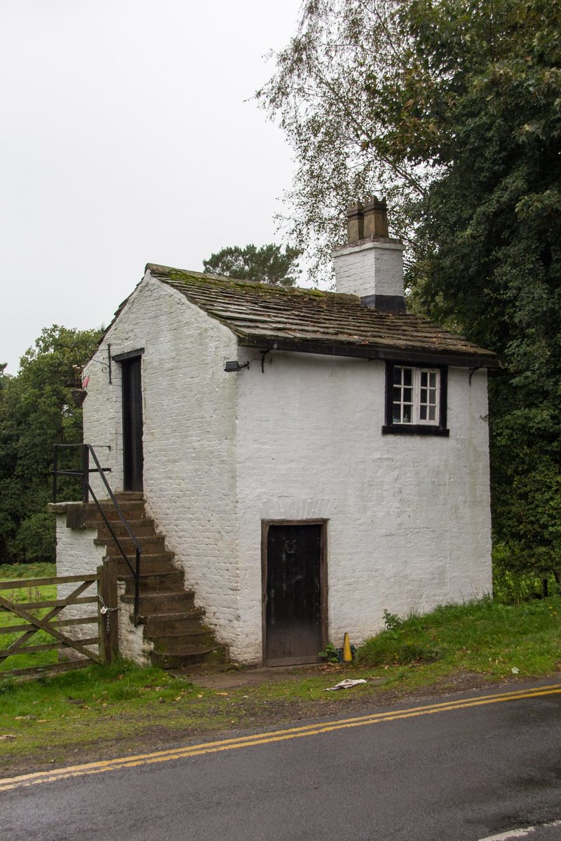 A surviving stone mine building at Alderley Edge, surrounded by woodland.