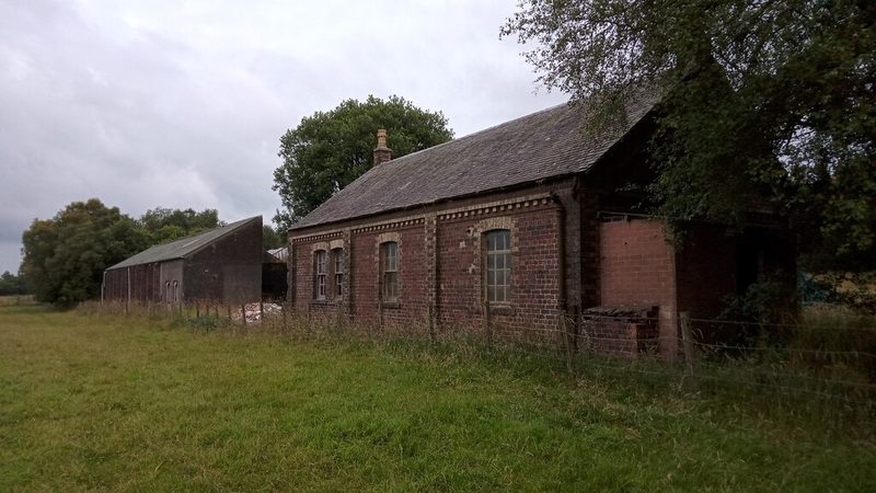 The surviving single-storey brick office and stores buildings of Baads No. 42 mine standing in a field near West Calder