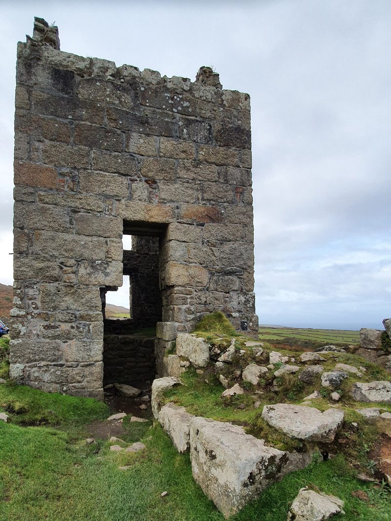 A roofless granite engine house of 1871 at Carn Galver Mine on the moor above the Zennor road.