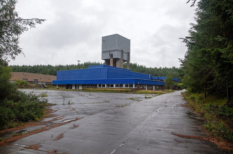 The surviving surface buildings and structures of Castlebridge Colliery standing among rough ground and trees in Clackmannanshire.
