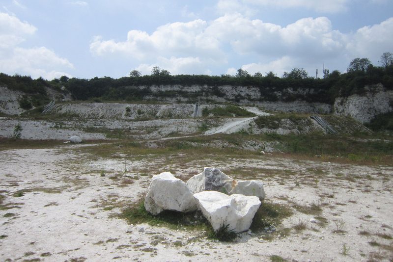 The chalk faces of East Pit at Cherry Hinton, with steps and fallen chalk blocks in view.