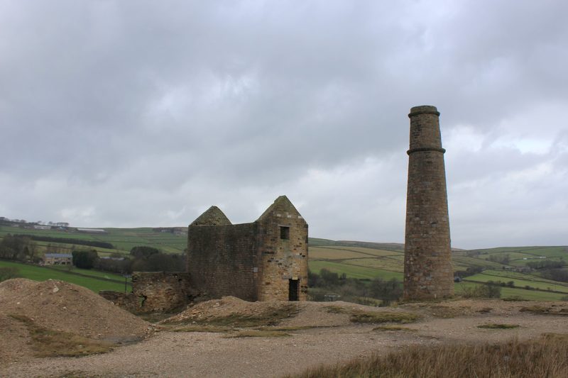 The roofless stone engine house and chimney of the former Cononley lead mine in North Yorkshire.