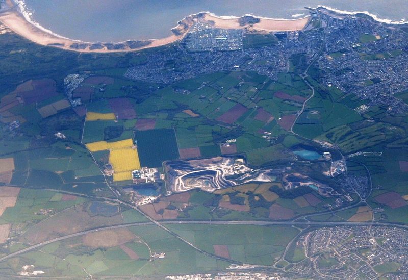 Cornelly Quarry seen from an airliner, the pale limestone benches cut into Stormy Down