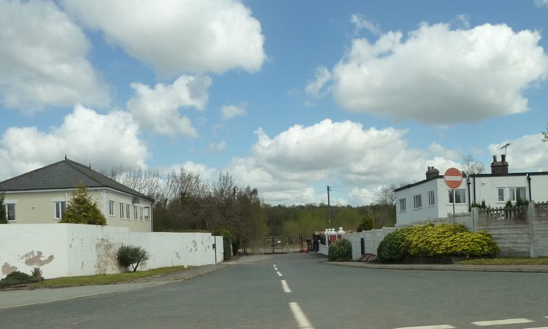 Colour photograph of the entrance road and gates to the former Cronton Colliery site, taken in 2013 before redevelopment began.