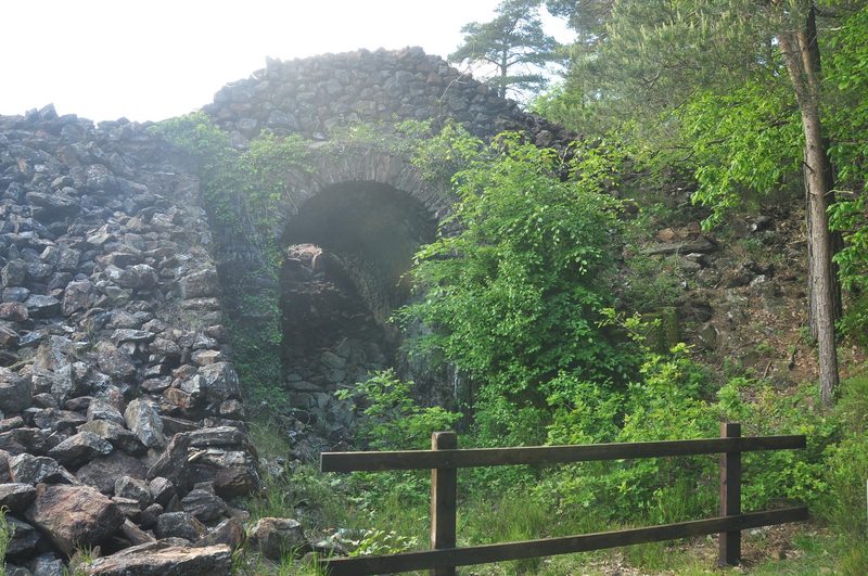 The arched brick calciner flues at Devon Great Consols, where arsenic was roasted out of the ore and condensed.