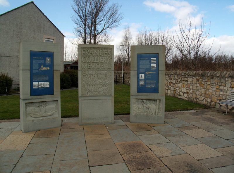 The preserved red-painted 1943 headframe of Frances Colliery, standing as a memorial above Dysart, Fife.