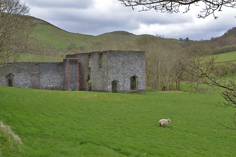 A roofless stone building among the remains of the Belgian-era dressing mill at Frongoch.