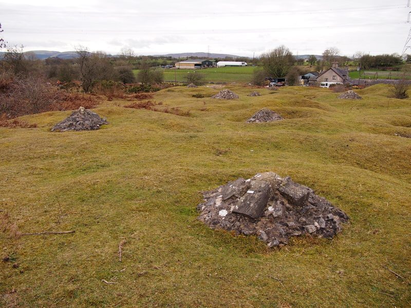 Concrete-capped shafts on the open common, two of the several thousand that survive across the mountain.