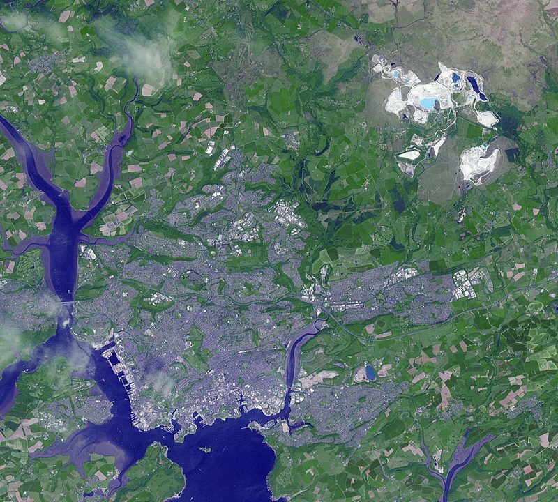 Satellite image of the open pit and its tailings and settling ponds cut into farmland north-east of Plymouth