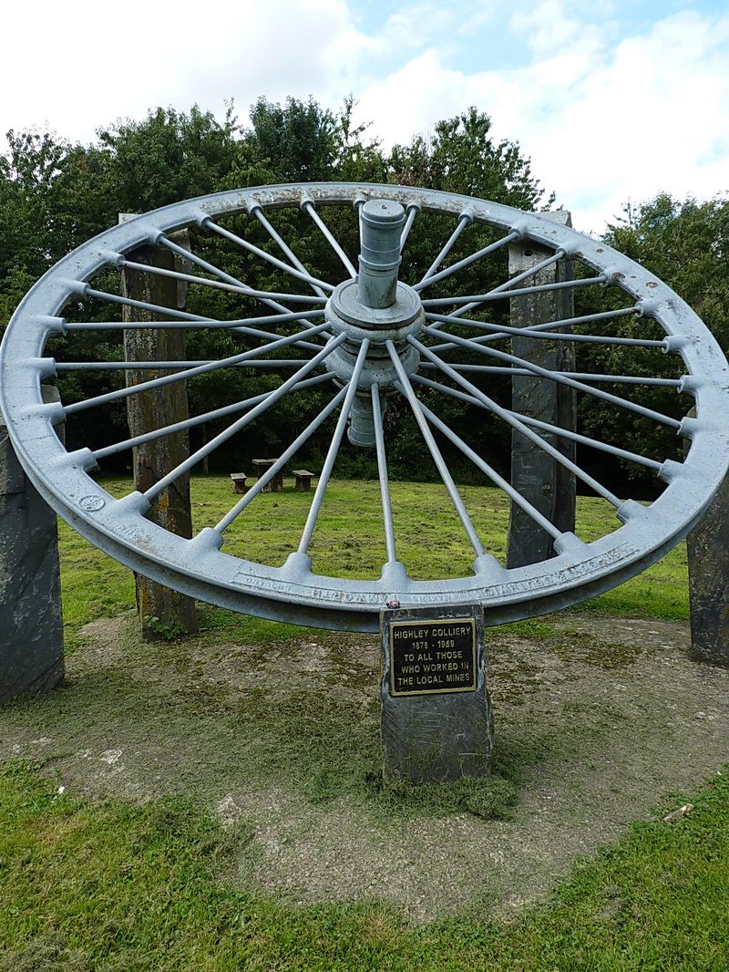 A cast colliery winding wheel set up as a memorial.