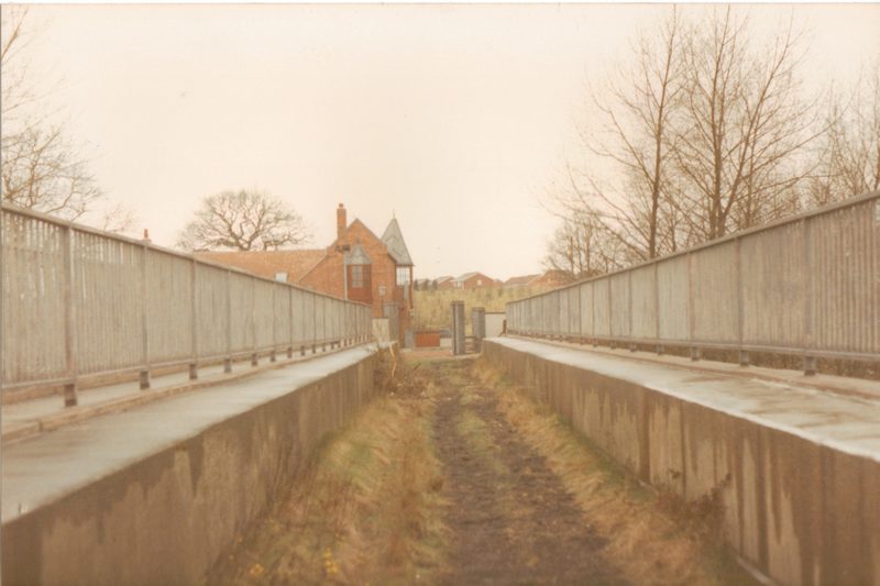 A brick-arched bridge carrying the former colliery railway line towards Holly Bank Colliery, with bare winter trees around it