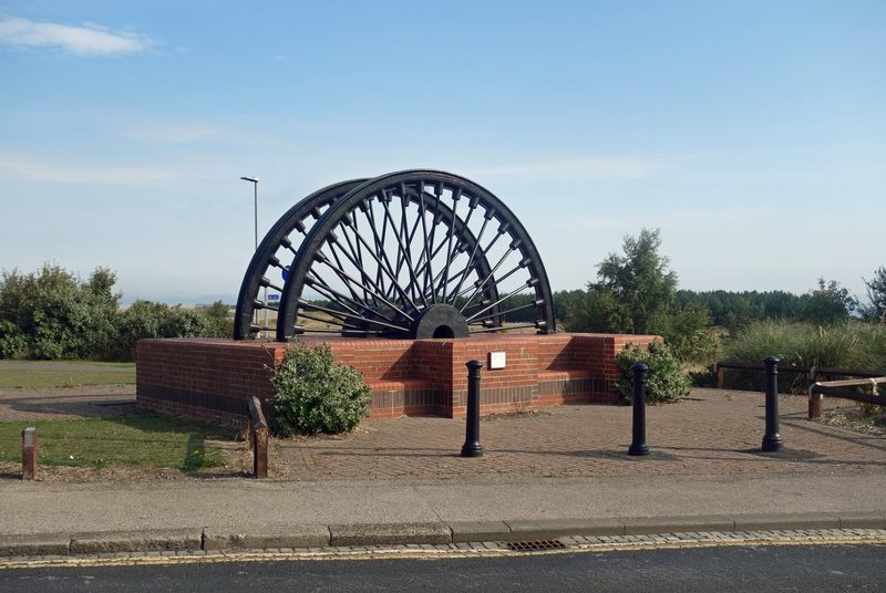 The Horden Colliery memorial, made from the colliery's own pit head winding wheels, standing on the former colliery site.