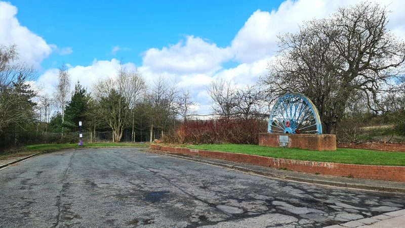 The Houghton Main memorial winding wheel beside the bus terminus at Little Houghton in 2025.