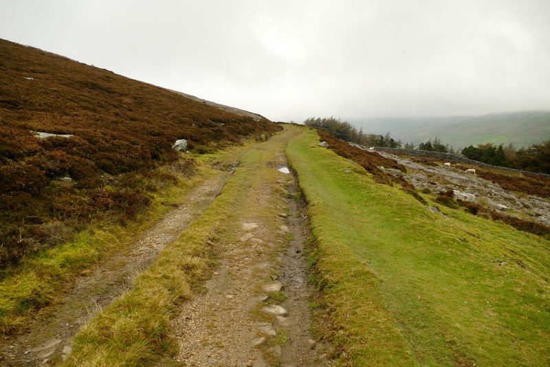 A miners' track contouring across open moorland towards the scoured gashes of the Hungry Hushes.