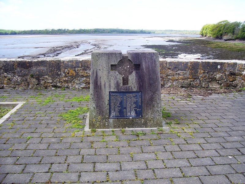 A stone memorial at Landshipping Quay bearing a plaque to those killed in the 1844 Garden Pit disaster, with the estuary behind.