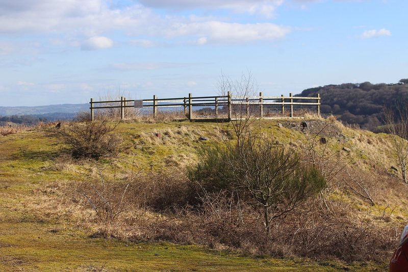 Fenced rough ground on the cleared site of Llanerch Colliery above Abersychan, with hillside behind.