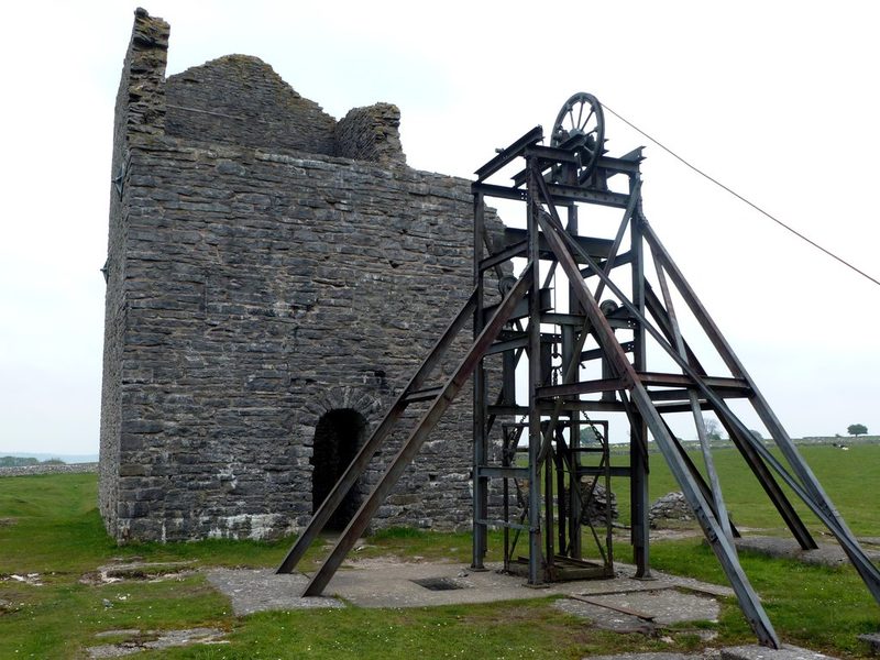 The 1869 Cornish engine house at Magpie Mine with the later headgear standing beside it.