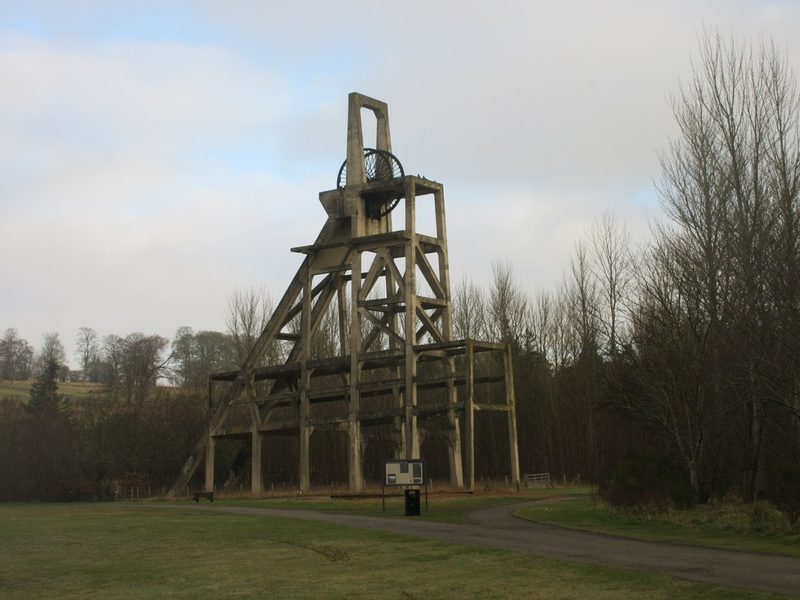 Reinforced-concrete headframe of the Mary Colliery No. 2 shaft with its winding wheel, standing in grass at Lochore Meadows Country Park.
