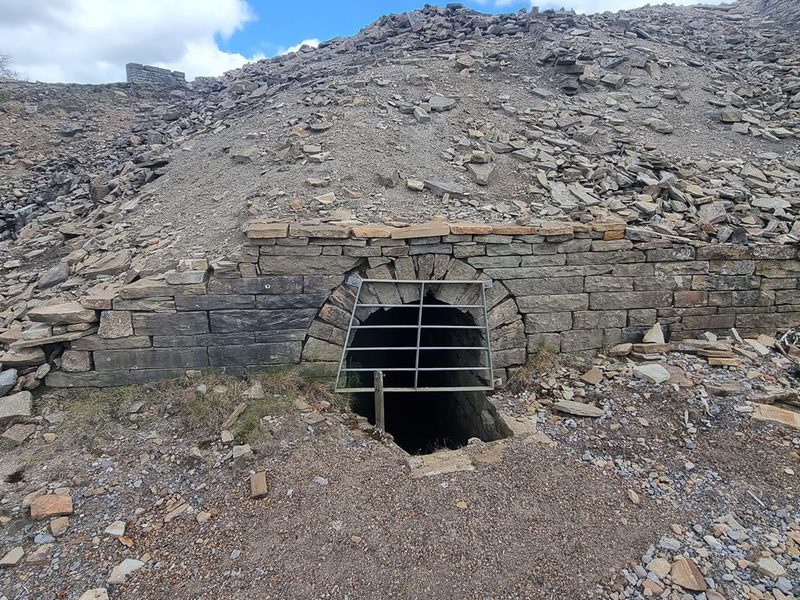 A stone-arched level entrance among the workings at Nenthead, photographed in 2024.