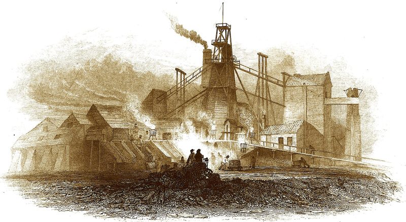 Sepia engraving of a colliery with a smoking timber headframe, sloping wooden screens and sheds, and figures standing by a fire on a coal heap in front.