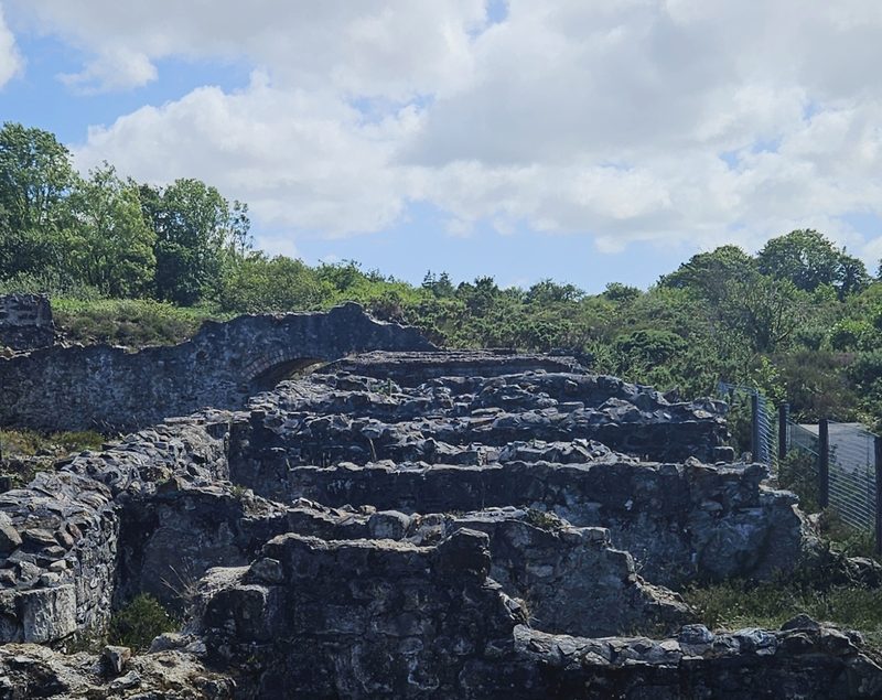The stone walls of the arsenic labyrinth at Poldice Mine, photographed in June 2026.