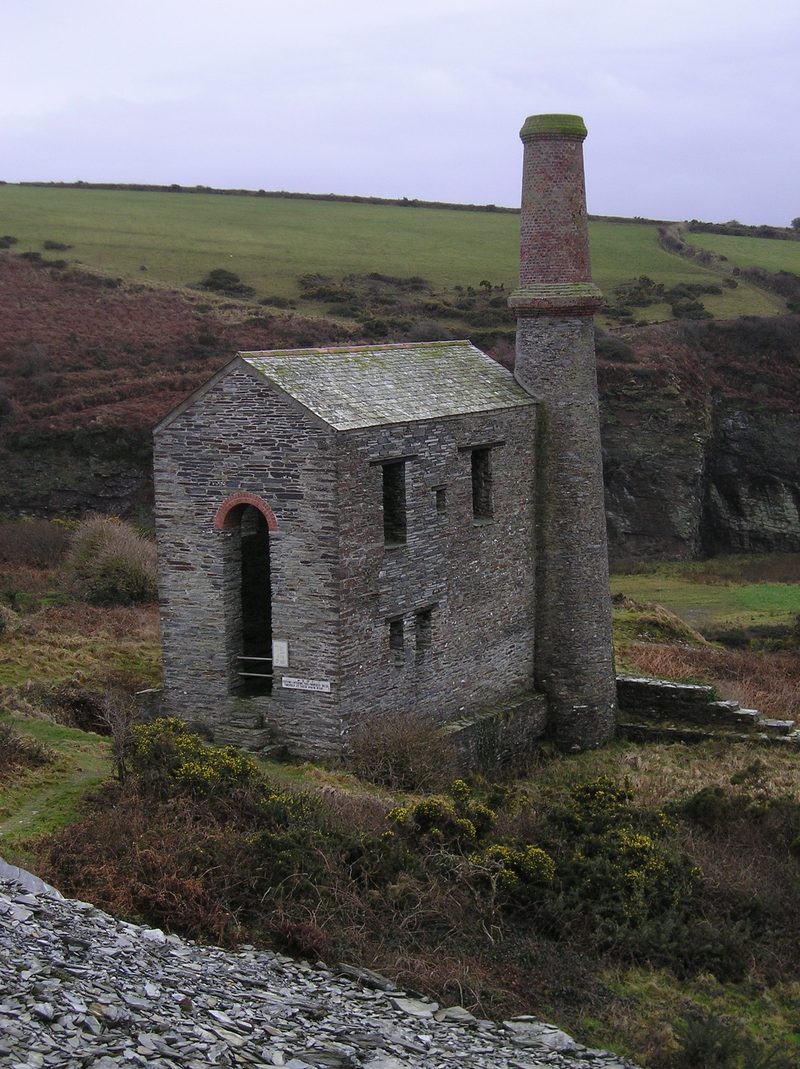 The ruined stone engine house and its tall chimney standing above the quarry in the Trebarwith valley.