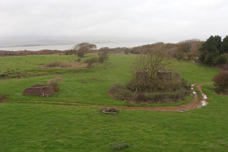 The flooded hollow of Sandscale No. 1 pit at Roanhead seen from the top of its spoil heap, with the dunes beyond.