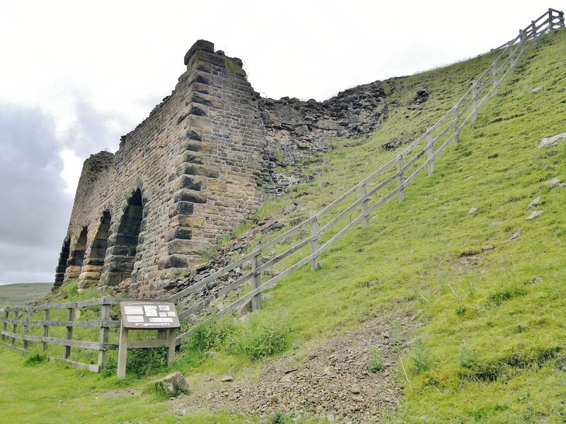 The row of iron calcining kilns at Rosedale East standing on the moorside, their brick and iron arches open to the weather.