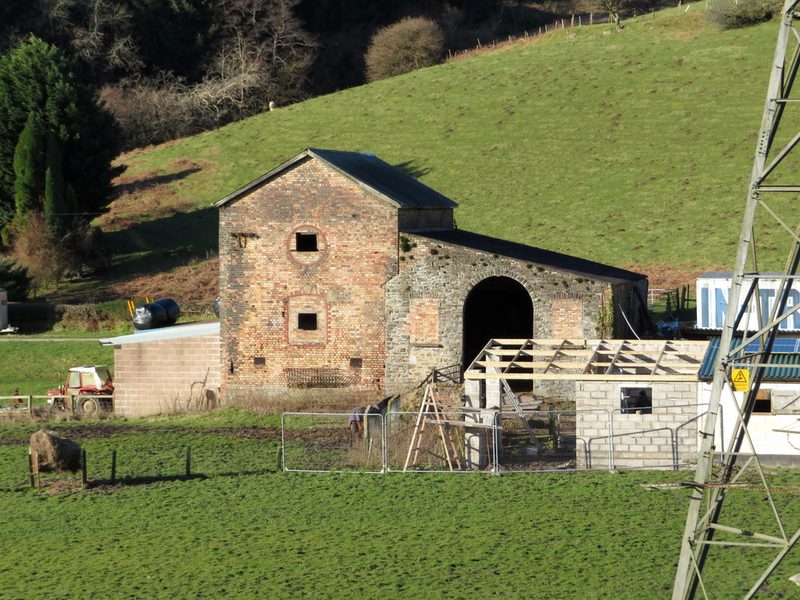 Old stone colliery buildings among farm buildings in the Llanbad valley near Llanharan.
