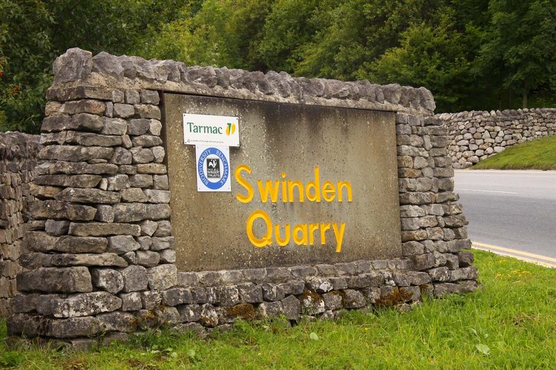 The entrance to Swinden Quarry near Cracoe in Wharfedale, with the working limestone quarry and its plant beyond