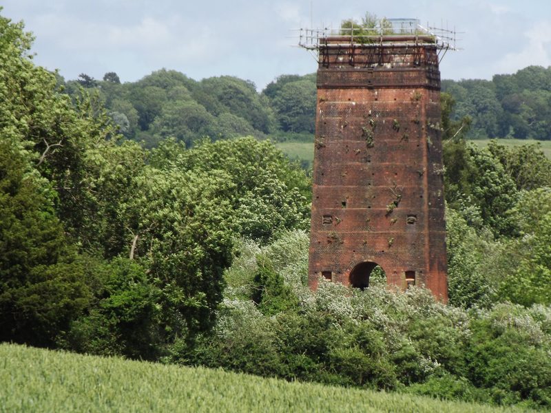 The derelict remains of a historic lime kiln on downland at Betchworth Quarry, Surrey.